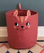 Large Roommate organic cotton storage cat basket in red with standing on a rug showing quilted finish on the inside