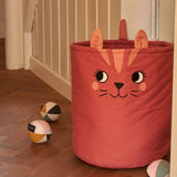 Large Roommate organic cotton storage cat basket in red standing next to sensory balls