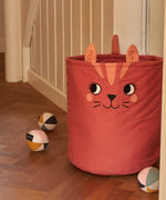 Large Roommate organic cotton storage cat basket in red standing next to sensory balls