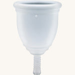 Ruby Cup Menstrual Cup in clear silicone, on a cream background
