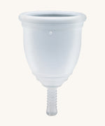 Ruby Cup Menstrual Cup in clear silicone, on a cream background