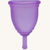 Ruby Cup Menstrual Cup in purple silicone, on a cream background