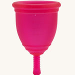 Ruby Cup Menstrual Cup in red silicone, on a cream background