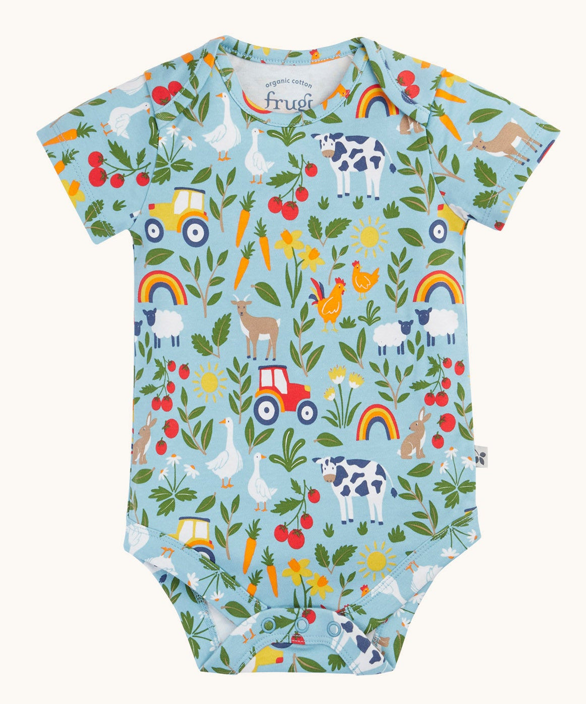 The farmyard all over print vest from the two pack of Frugi short sleeve baby vests. The print features farm animals, tractors, leaves and plants on a light blue background.