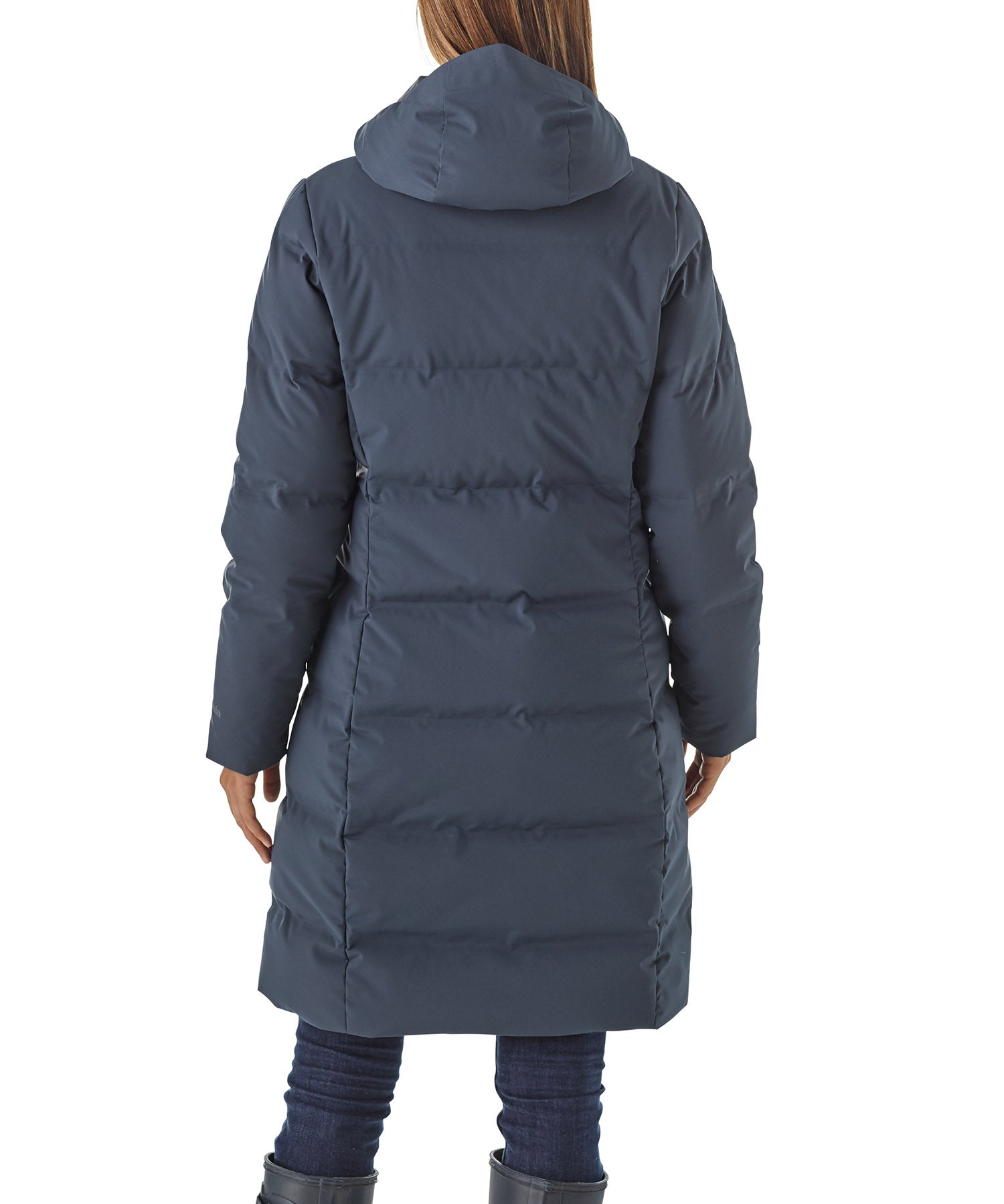 Person wearing a long blue puffer coat on a white background