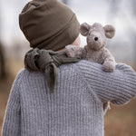 A child holding the Senger Baby Mouse in their arm, with the mouse showing over the child's right shoulder. The image is showing the back of the child