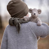 A child holding the Senger Baby Mouse in their arm, with the mouse showing over the child's right shoulder. The image is showing the back of the child