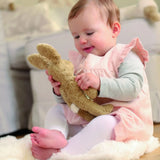 Senger baby rabbit in beige with small white fluffy tail, made with organic cotton and stuffed with wool, held by baby.