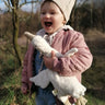 Senger naturwelt white small goose toy, made from organic cotton, held by child.