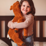 Senger Naturwelt Large Cuddly Deer Soft Toy, made from wool and organic cotton, cuddled by girl.