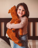 Senger Naturwelt Large Cuddly Deer Soft Toy, made from wool and organic cotton, cuddled by girl.
