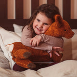 Senger Naturwelt Large Cuddly Deer Organic Soft Toy, made from wool and organic cotton, held by child on bed.