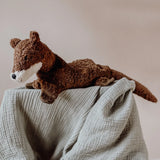 Senger Naturwelt seal, a small brown cuddly soft toy made from natural materials, on a grey muslin blanket.