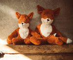 Senger Naturwelt Floppy Fox soft toy in large and small, both made from organic cotton, on a shelf.