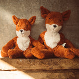 Senger Naturwelt Floppy Fox soft toy in large and small, both made from organic cotton, on a shelf.