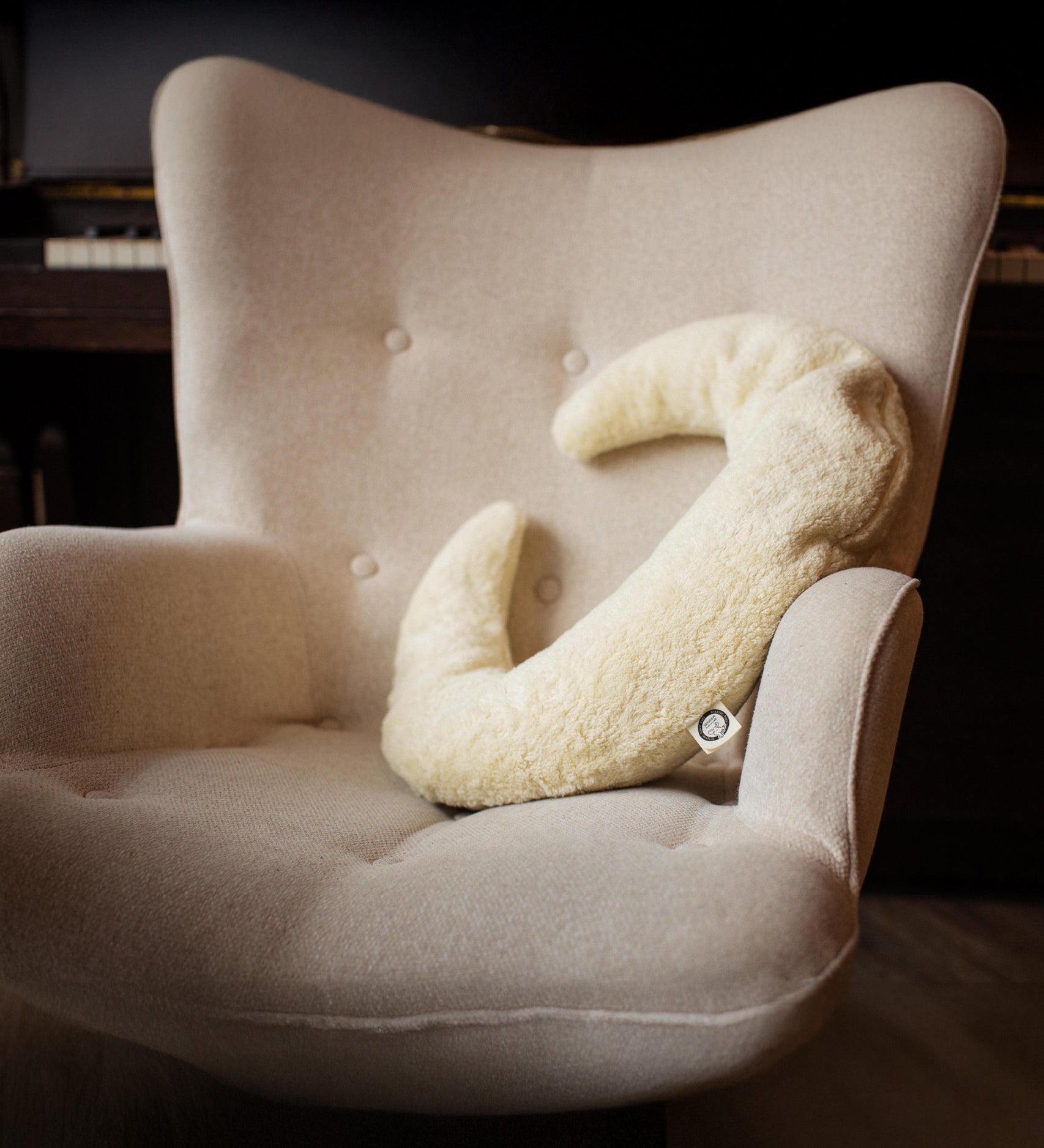 A Senger nursing and neck cushion available at Babipur. Cushion is in a shape of a white moon and made for supporting the neck and assisting while feeding. 