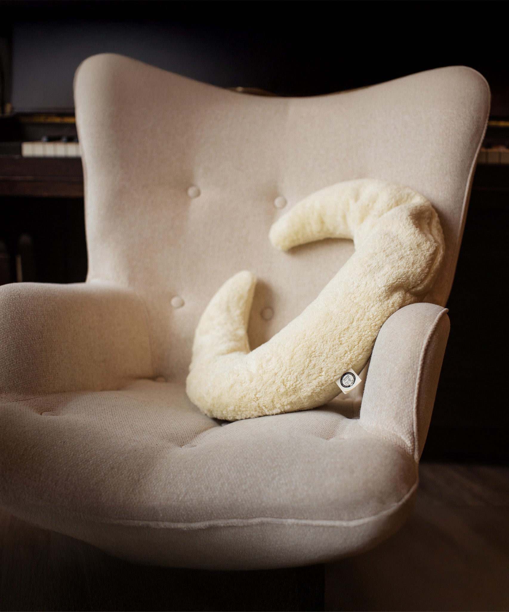 A Senger nursing and neck cushion available at Babipur. Cushion is in a shape of a white moon and made for supporting the neck and assisting while feeding. 