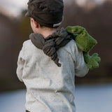 Senger Naturwelt Cuddly Green Small Frog soft toy, made from organic cotton, over child's shoulder.