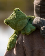 Senger Naturwelt Small Cuddly Frog soft toy, made from organic cotton, in child's arms.