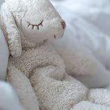 Senger Small Cuddly White Sheep, sat peacefully on a white blanket