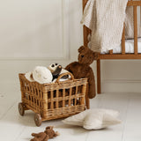 A GOTS organic cotton snowy owl soft toy by Senger available at Babipur sitting in a play basket next to a Senger brown cuddly bear 