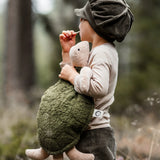 Senger Naturwelt large green cuddly turtle soft toy held by child.