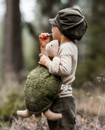 Senger Naturwelt large green cuddly turtle soft toy held by child.