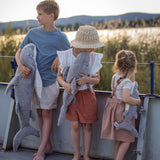 Children holding the different sized Senger Naturwelt grey Cuddly Shark toys outdoors, organic heatable soft toy with GOTS cotton outer and spelt husk cushion.