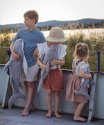 Children holding the different sized Senger Naturwelt grey Cuddly Shark toys outdoors, organic heatable soft toy with GOTS cotton outer and spelt husk cushion.