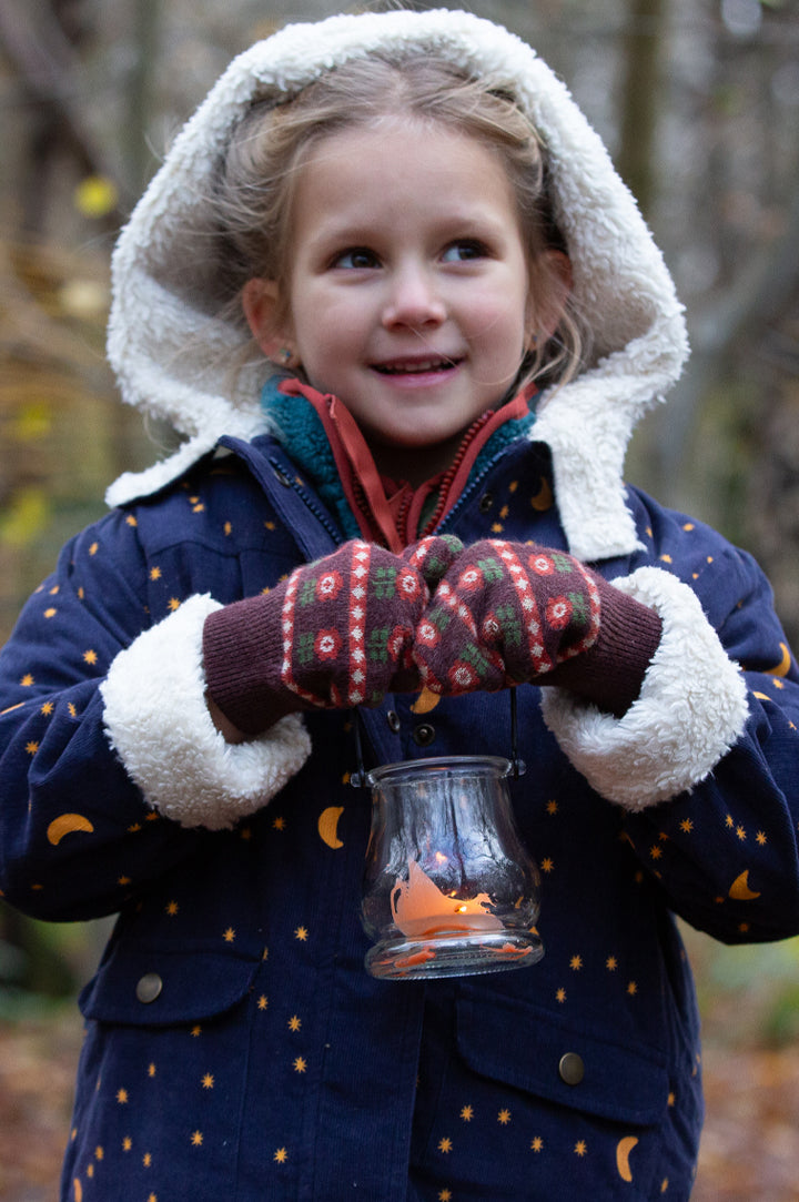 Child wearing a Little Green Radicals organic cotton Sherpa Toasty Coat in Dark Night print - dark blue with yellow moons and stars - with a cosy fluffy hood and cuffs - to represent Little Green Radicals Coats at Babipur.