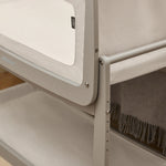 A closeup of the corner of the wooden grey SnuzPod5 bedside crib, showing where the bassinet can detach from the main rocking frame. 