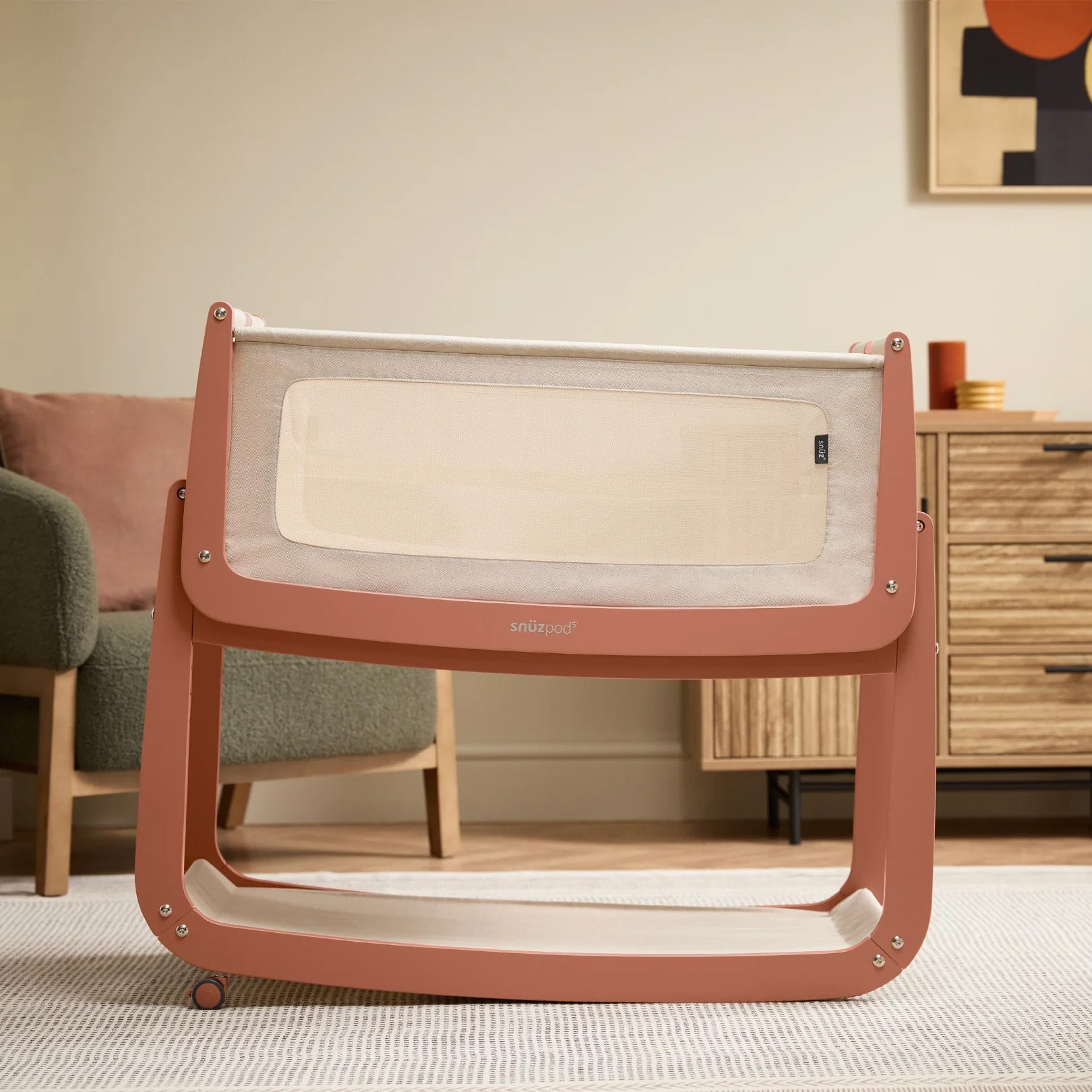 The SnuzPod5 in Terracotta with only 2 of its 4 wheels attached, to show the 'comfort incline mode'.