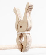 Speelbelovend giant wooden peg on wooden frame pole. Peg held by e rubber band for extra grip