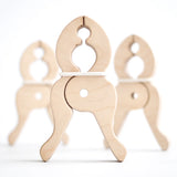 A trio of Speelbelovend wooden giant pegs made for hanging fabrics in Triclimbs and Trigonos dens