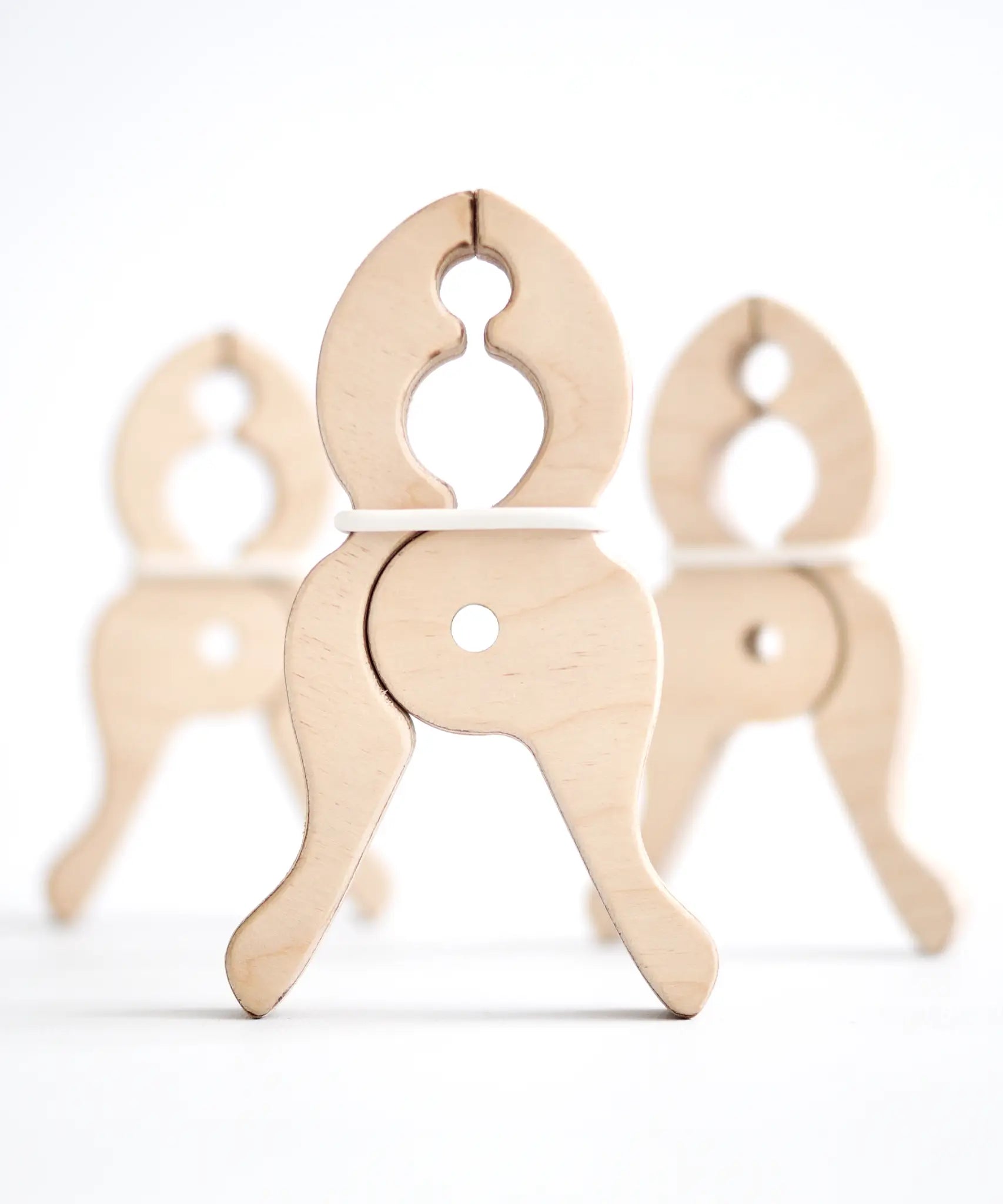 A trio of Speelbelovend wooden giant pegs made for hanging fabrics in Triclimbs and Trigonos dens