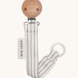 Avery Row Pacifier Holder - Stripe, showing the silicone ring and wooden clip