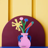 Studio roof Matisse Paper Bloom inspired bouquet 3D pop out card decoration available at Babipur displayed on a blue table against a yellow wall