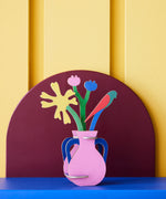 Studio roof Matisse Paper Bloom inspired bouquet 3D pop out card decoration available at Babipur displayed on a blue table against a yellow wall