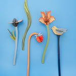 The Studio Roof Cardboard Bouquet - William Morris pieces laid flat on a light blue background