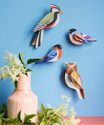 Studio Roof tawny owl wall decoration available at Babipur hanging on a blue wall next to a Studio Roof woodpecker and 2 finches. 