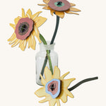 Studio Roof Cardboard Bouquet - Van Gogh Sunflowers, stood in a glass vase on a cream background