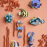 A group of Studio Roof sealife animal wall decorations available at Babipur hanging on a lightly coloured wall including a small sea turtle
