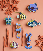 A group of Studio Roof sealife animal wall decorations available at Babipur hanging on a lightly coloured wall including a small sea turtle