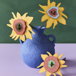 The Studio Roof Cardboard Bouquet - Van Gogh Sunflowers in a blue vase, on a green and lilac background