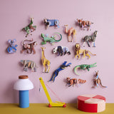 The Studio Roof Wildlife Animals 3D Cardboard Models collection all displayed on a pink background - 16 in total. They are displayed with a collection of decorative items on a table.
