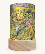 The Summer Hour illustration by Kapitein Kalk sat in a Toverlux Magic Lantern base, on a cream background