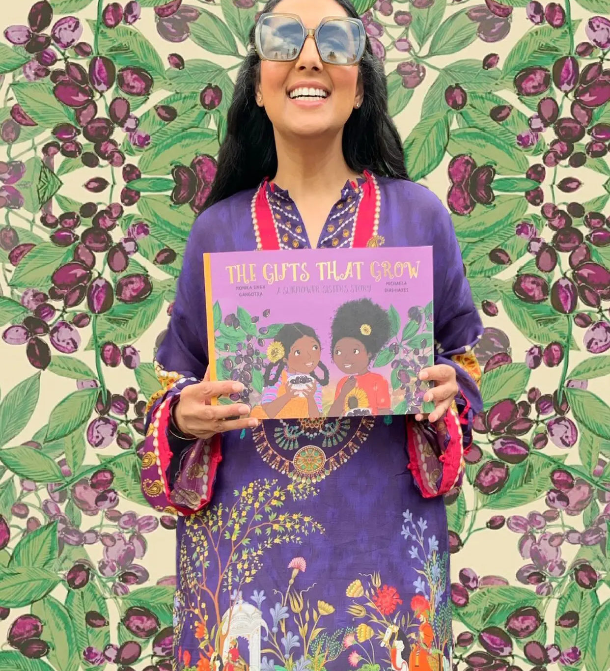 The Gifts That Grow children's book held by author Monika Singh Gangotra.