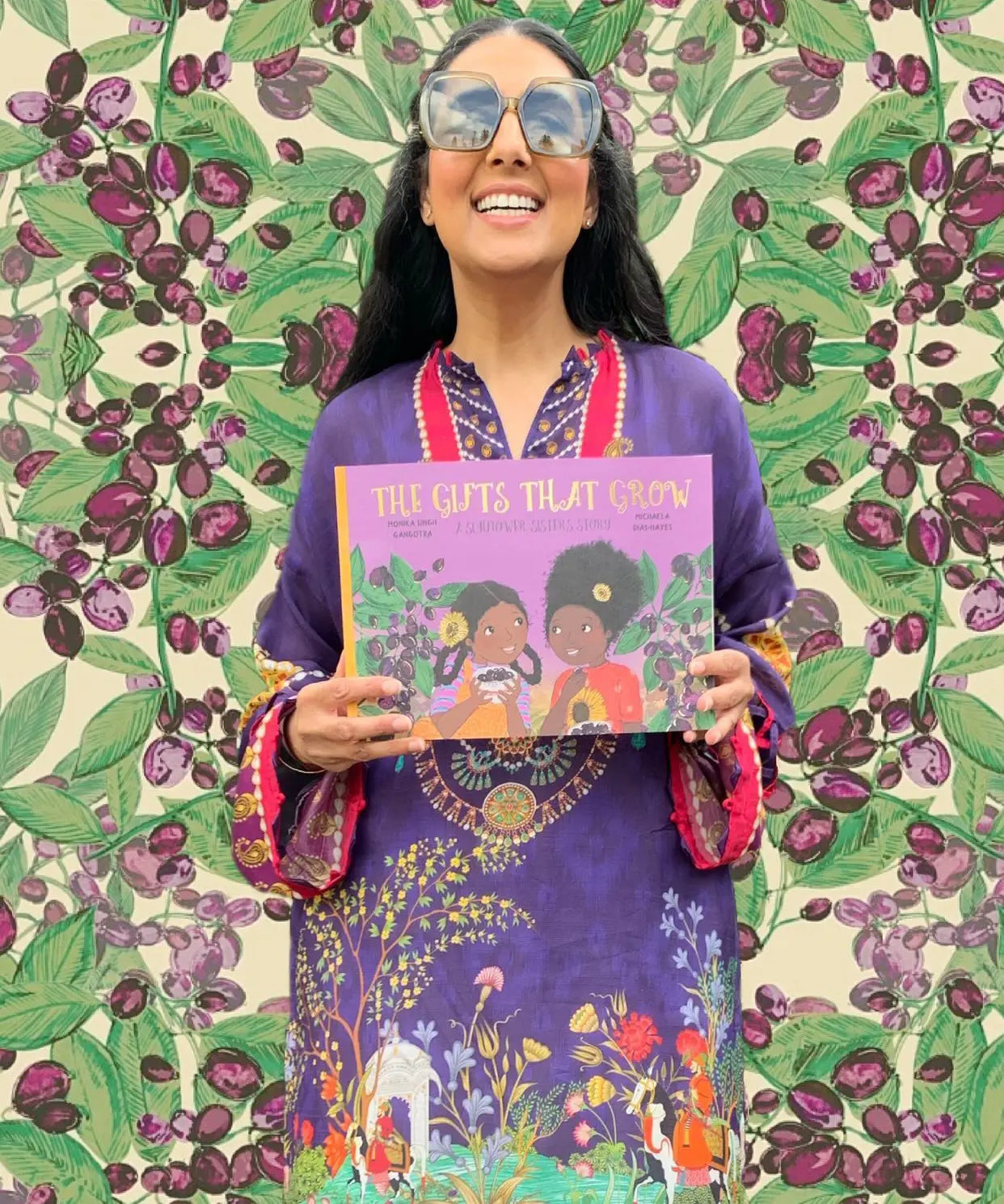 The Gifts That Grow children's book held by author Monika Singh Gangotra.