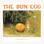 The Sun Egg by Elsa Beskow, is a beautifully illustrated children's story book. The image shows a small fairy with what appears to be an egg on the ground. The fairy is looking curiously at the suspicious egg as a butterfly passes by