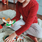 A close up of a child holding some of the piece from the Bajo abstract art puzzle set available at Babipur showing scale 